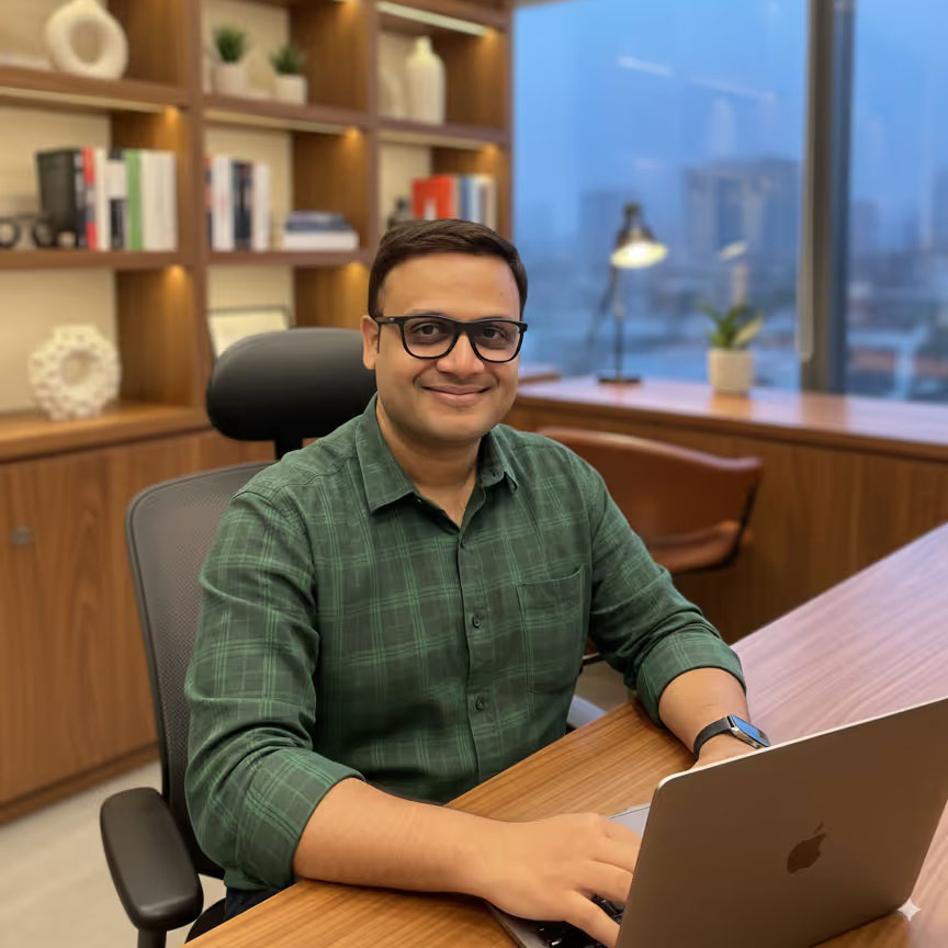 portrait of a indian man sitting at his work desk