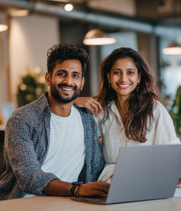 indian couple smiling looking at their financial report