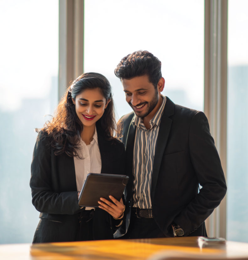indian couple smiling looking at their financial report