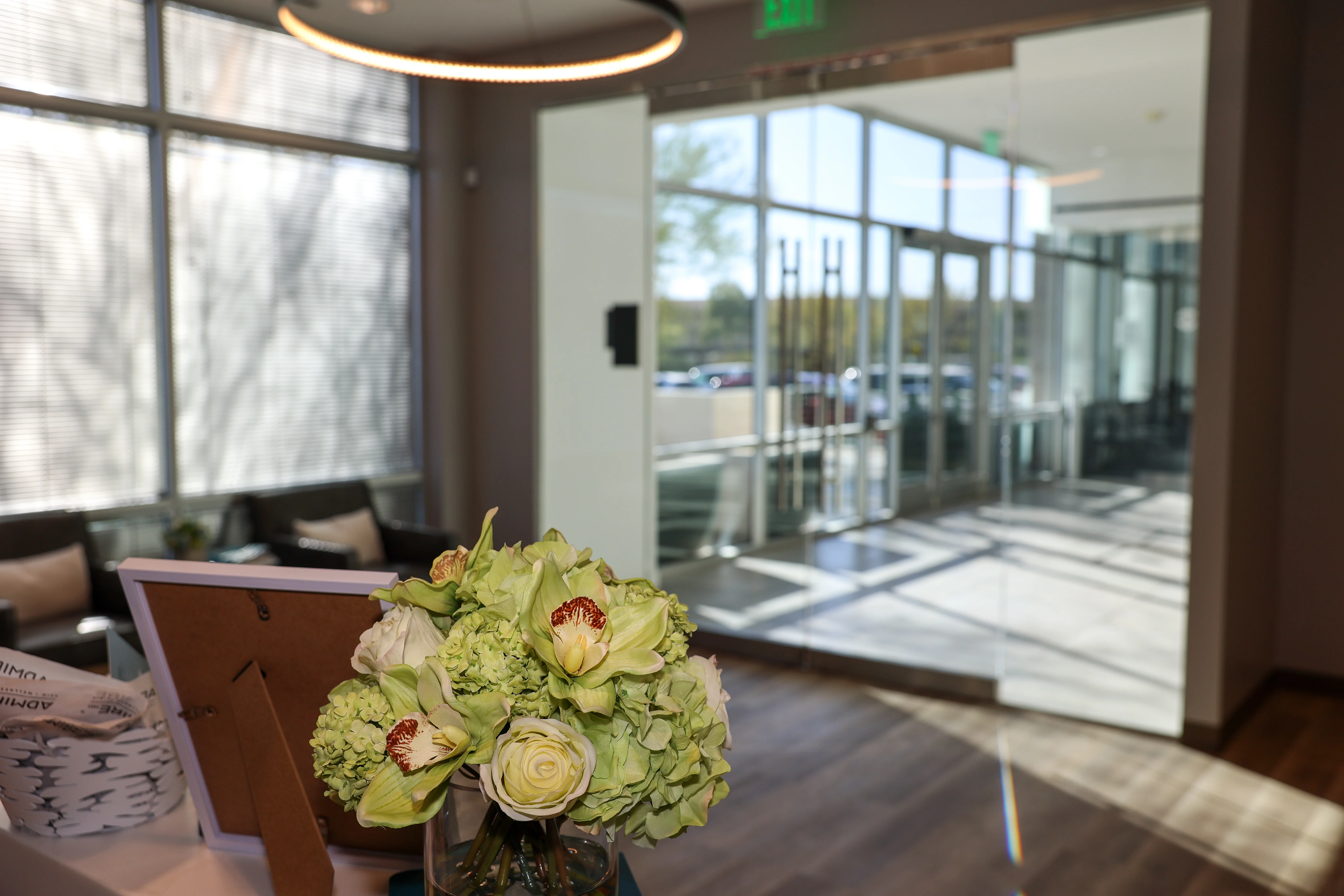 Reception desk with flowers and bright natural light at Metropolitan Plastic Surgery Scottsdale office entrance.