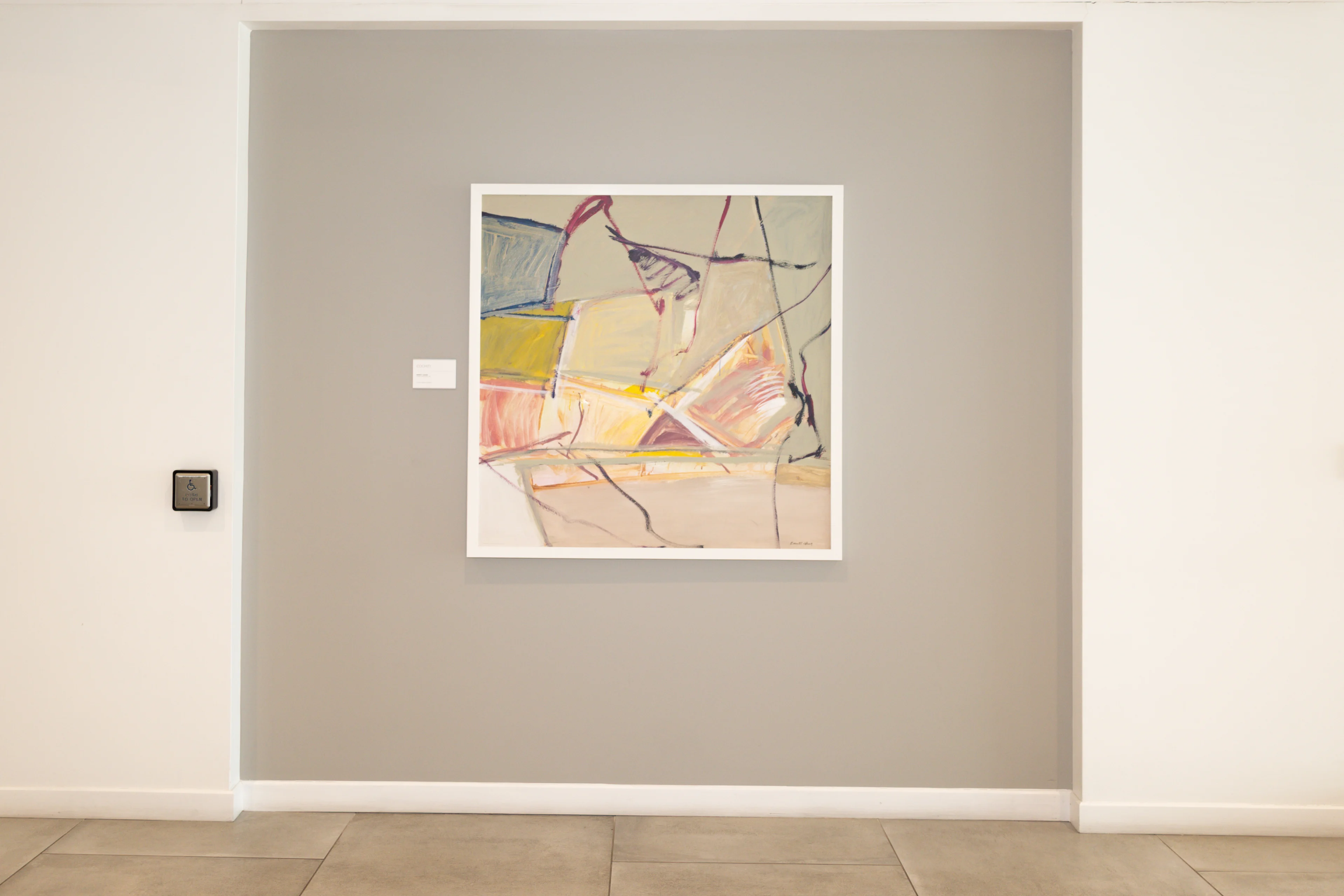 Framed abstract artwork on a gray accent wall in the modern lobby of Metropolitan Plastic Surgery Scottsdale.