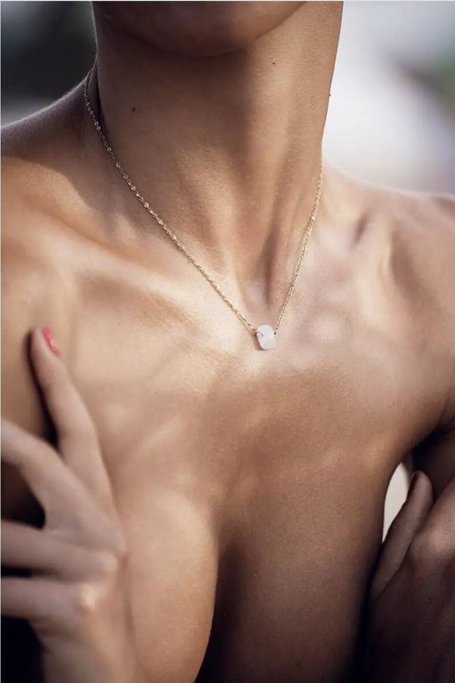 Close-up of female neckline and chest with natural-looking cleavage after breast augmentation
