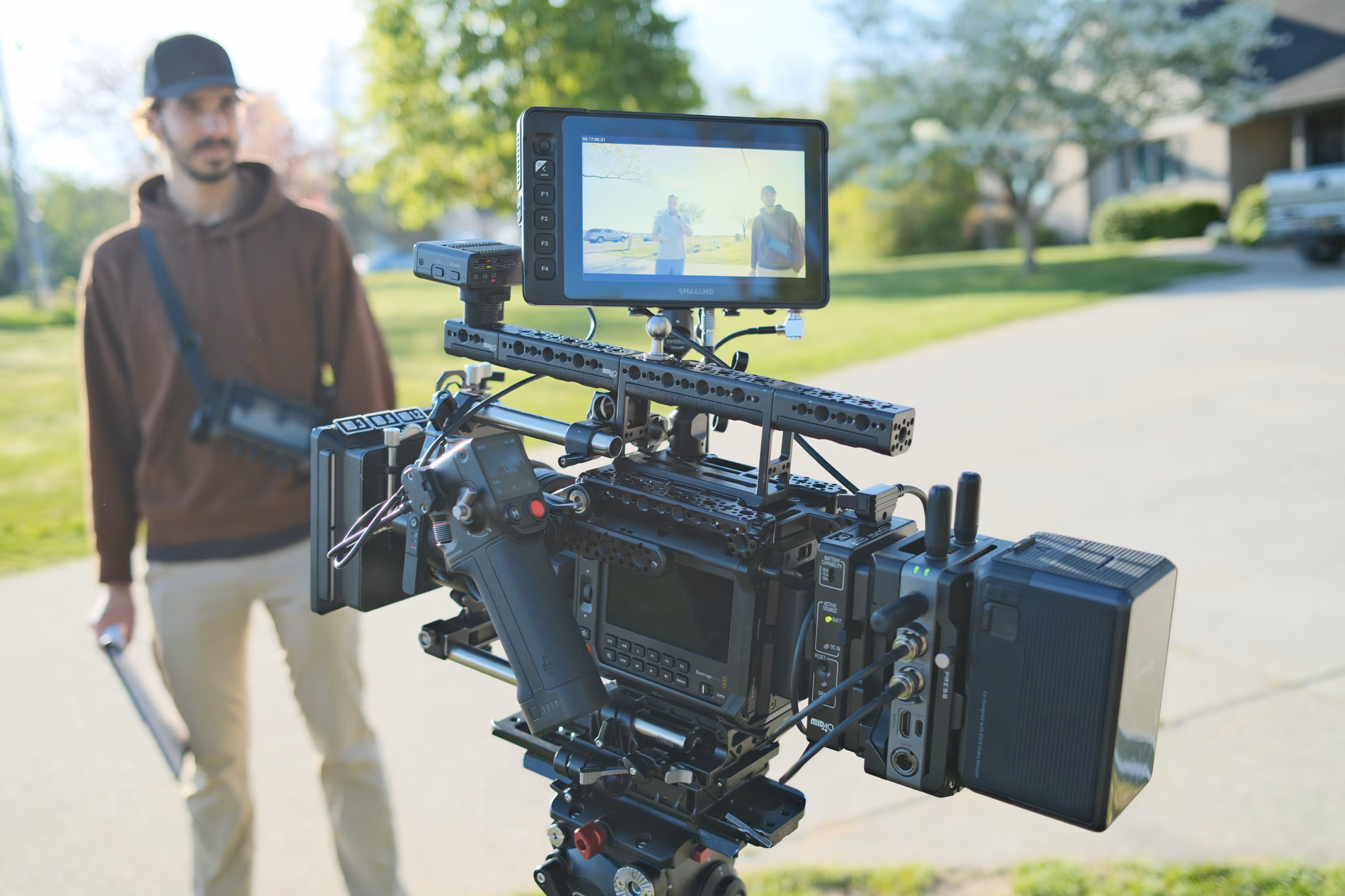 A behind-the-scenes picture of a camera set up with a man.