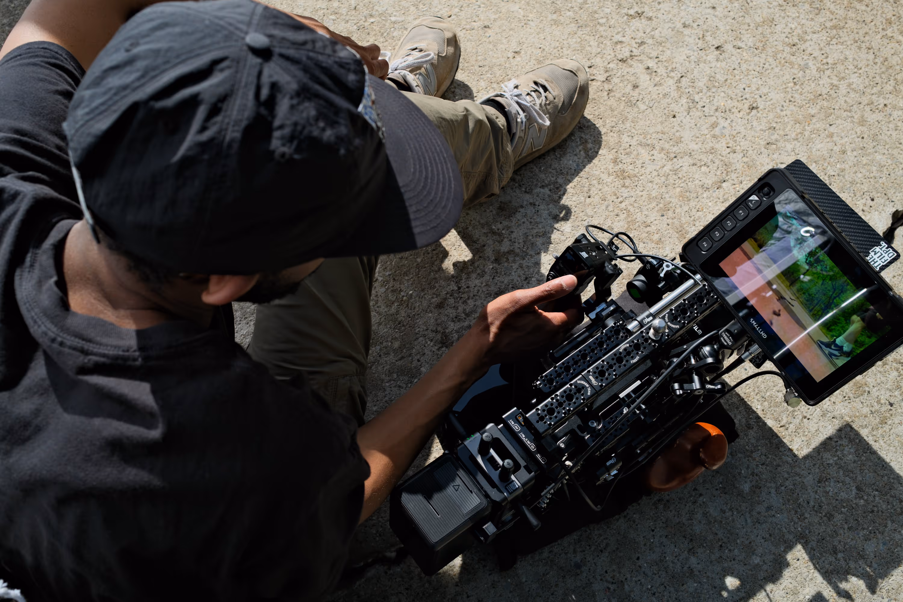 A behind-the-scenes picture of a man reviewing a shoot with a camera