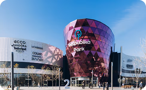 A large building with a purple triangle on top of it.