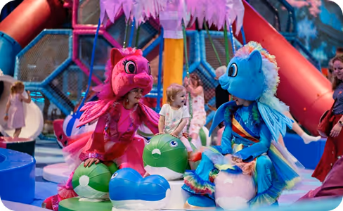 A group of children in costumes on a stage.