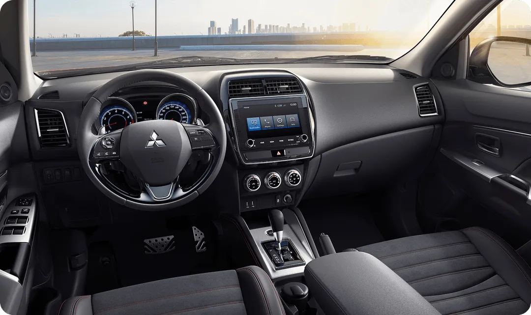 The interior of a car with a dashboard and steering wheel.