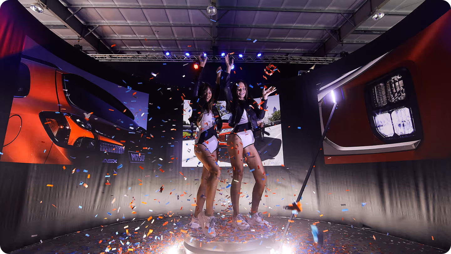 A couple of women standing on top of a stage.
