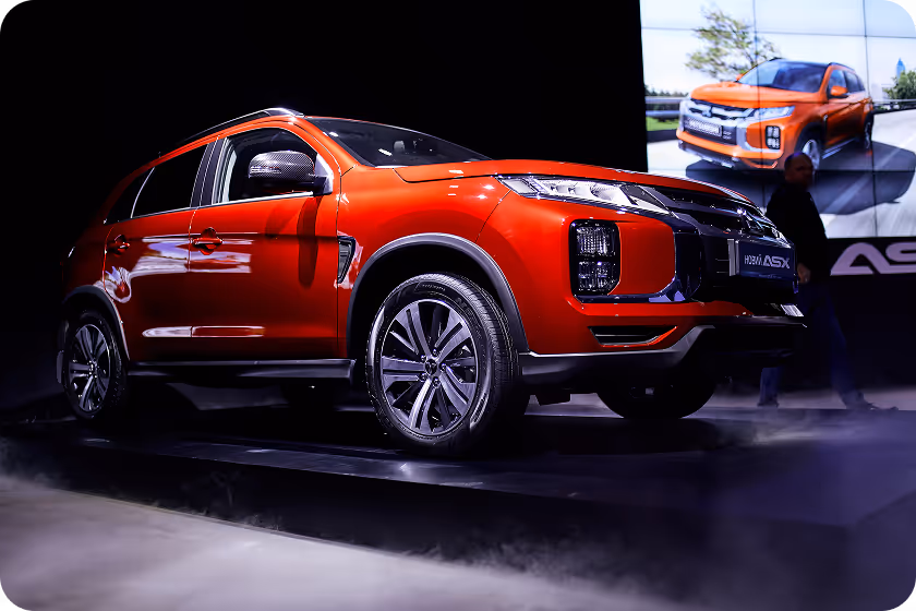 A red suv is on display at an auto show.