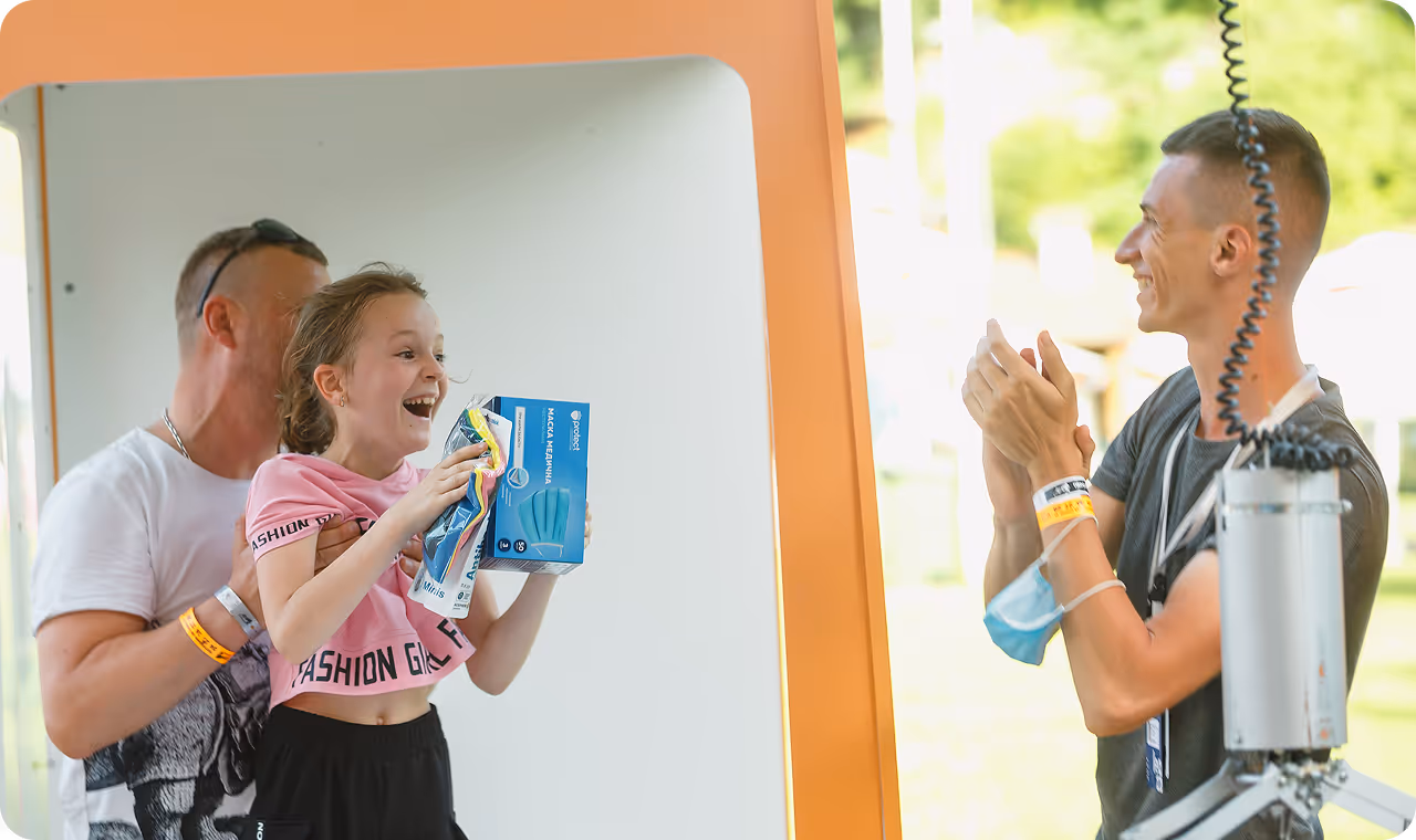 A man and a little girl standing in front of a mirror.