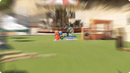 A blurry photo of a park with a sign.
