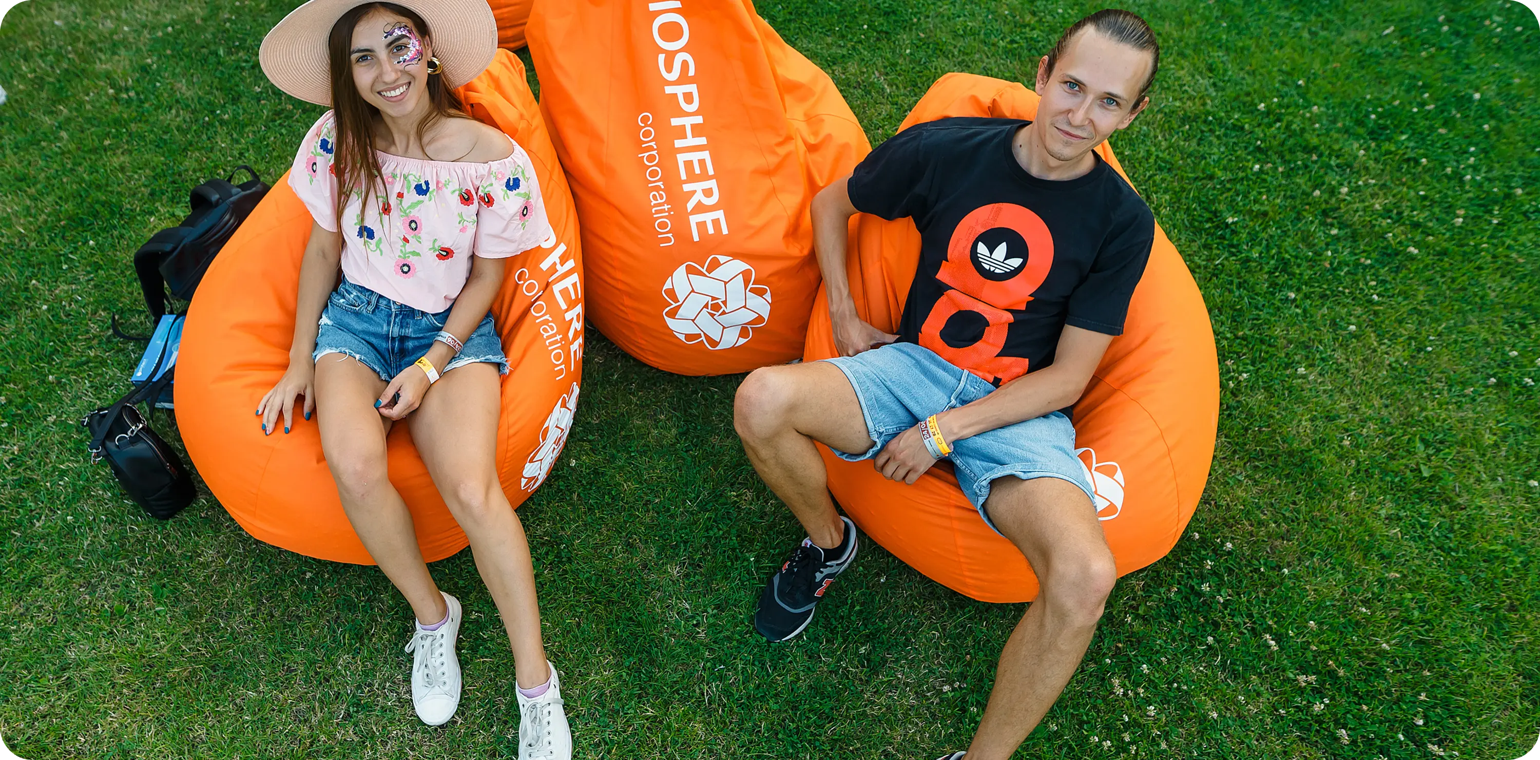 A man and a woman sitting on bean bag chairs.