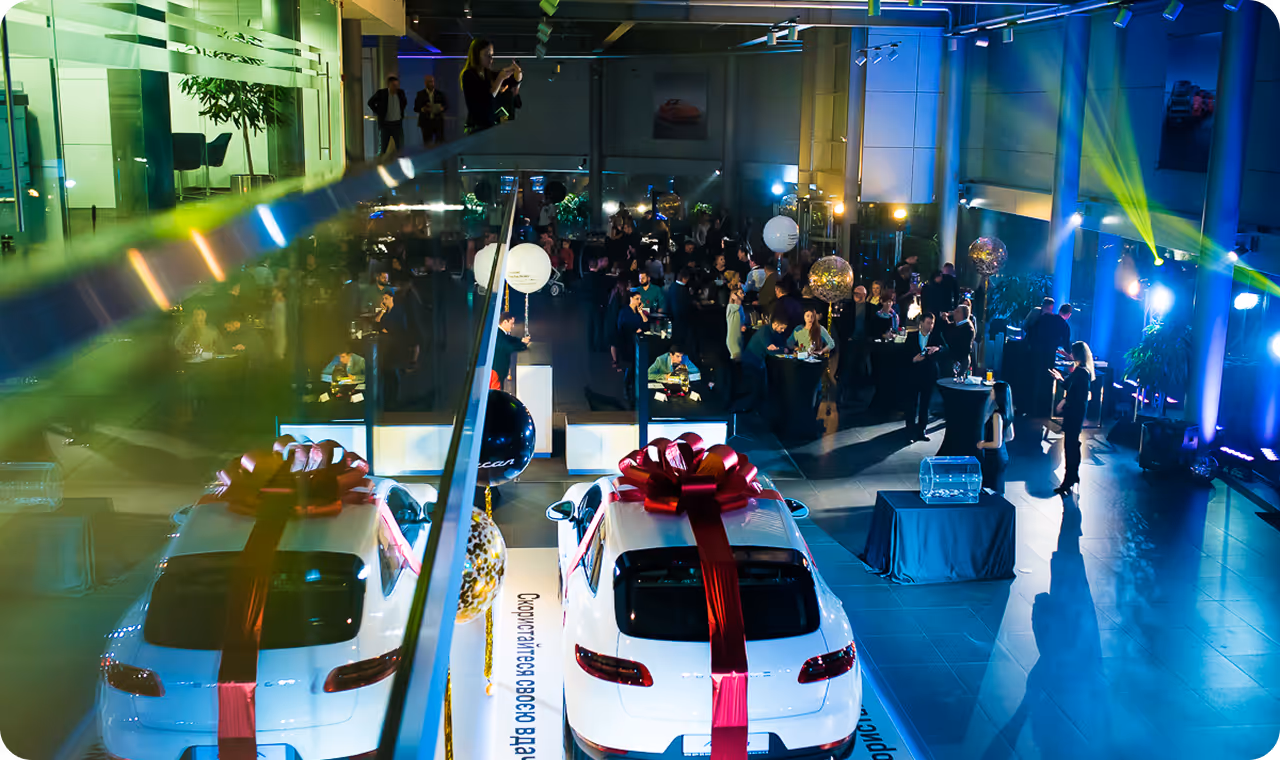 A group of people standing around a white car.