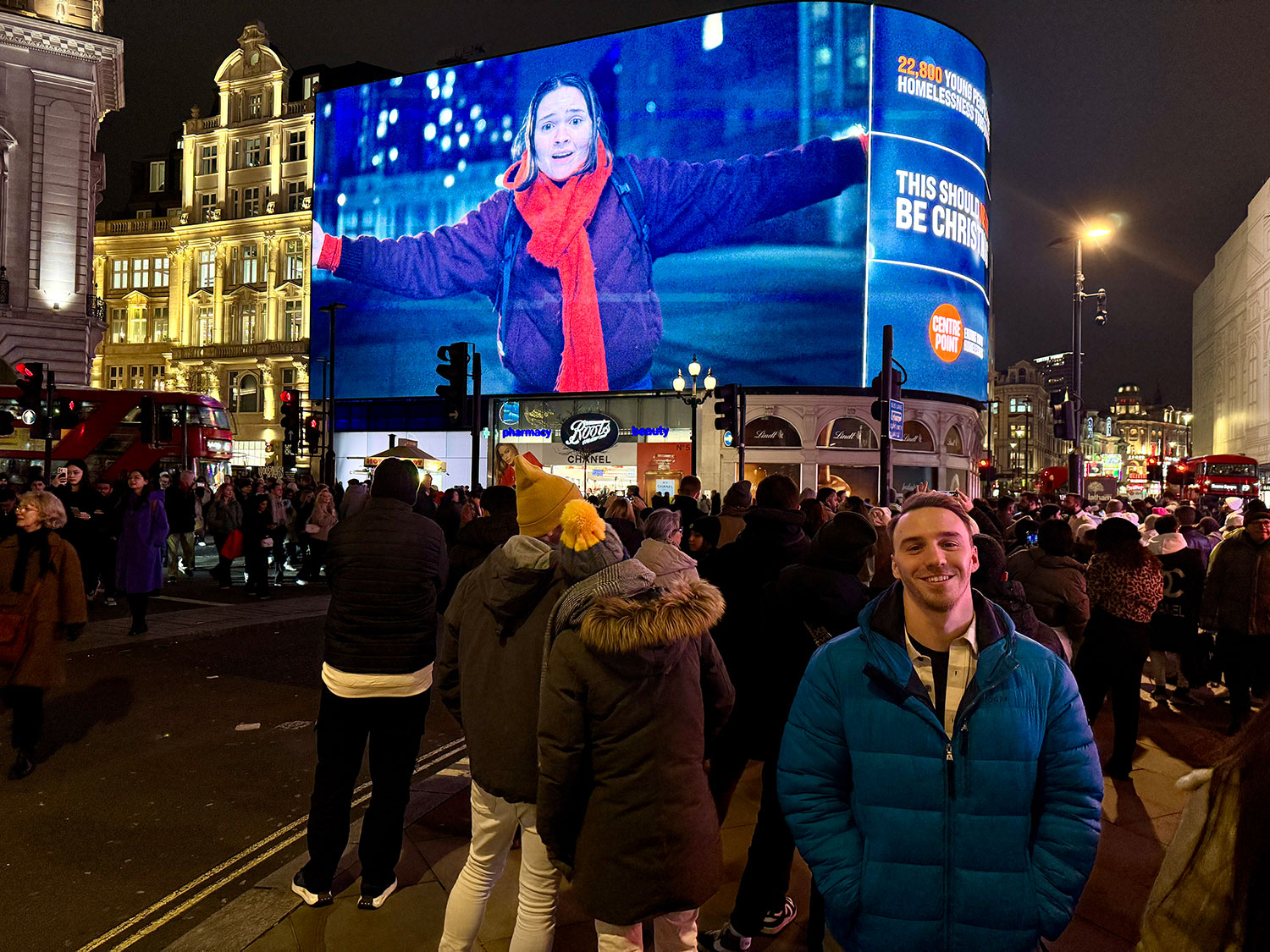 Picture of Tom in front of his ad at Piccadilly Circus, London. 

