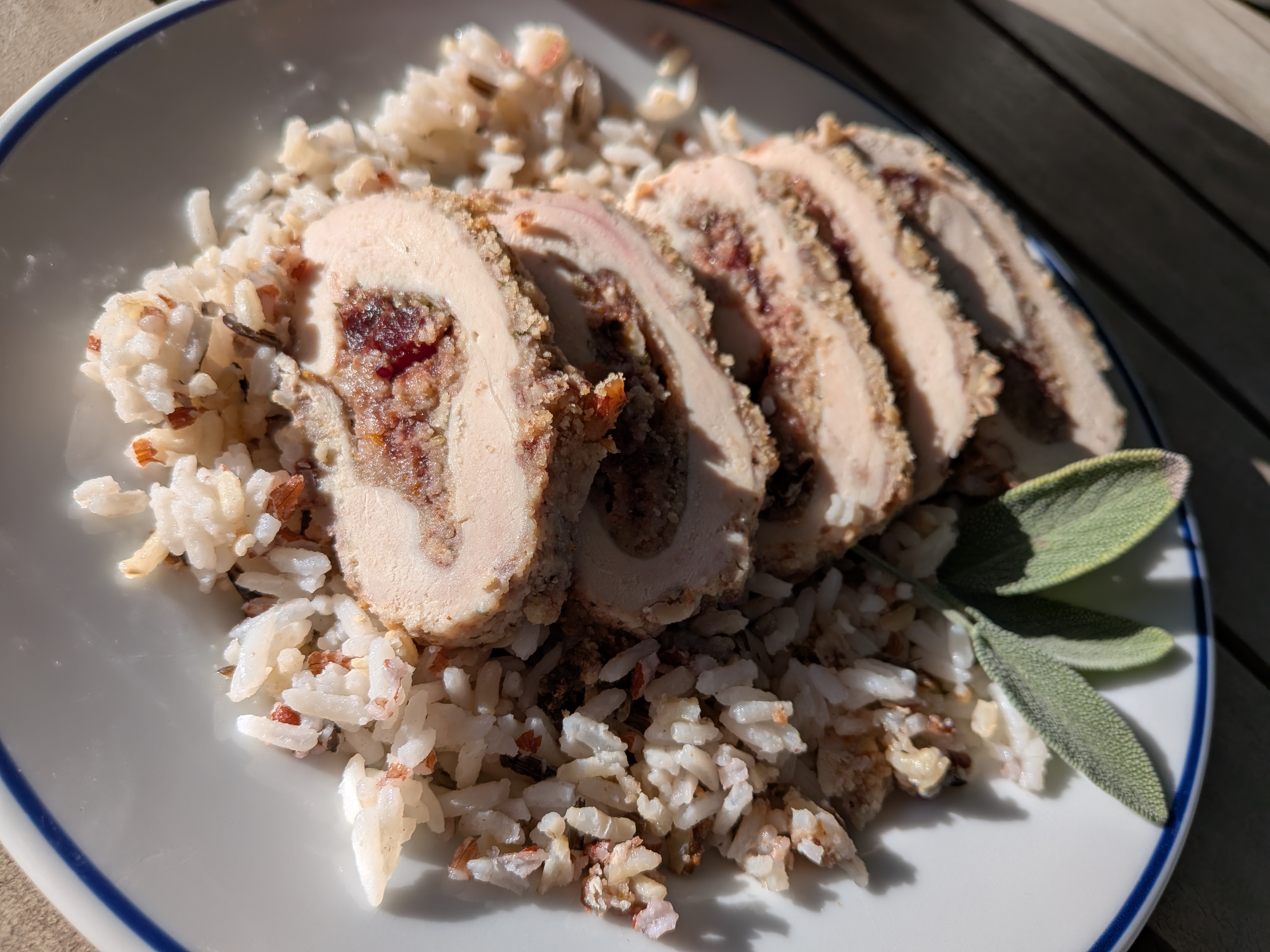 Sliced Pecan Encrusted Chicken on a bed of wild rice (serving suggestion)