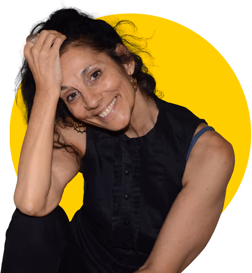 Myriam López sitting in a relaxed pose, smiling.