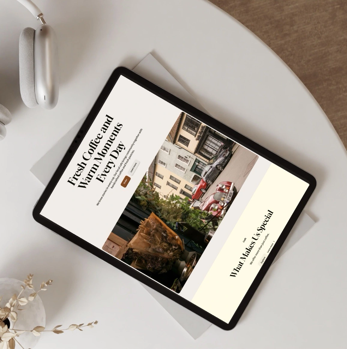 Laptop on desk displaying the Mapping Advertising Assets Project (MAAP) Leeds website, surrounded by a gold lamp, books, glasses, and a cup on a saucer.