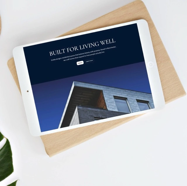 Open laptop on a white table displaying a map of the United Kingdom with blue dots labeled 'Priority Places for Food Index'.