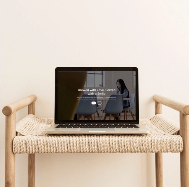 Desktop computer on a wooden desk displaying the Welcome page of the Carbon Footprint Calculator website with instructions and menu options.