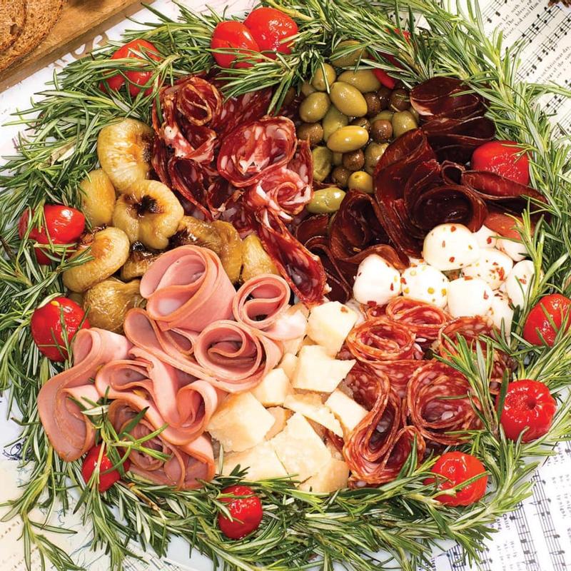 A platter featuring an assortment of meats, cheeses, and fresh vegetables.