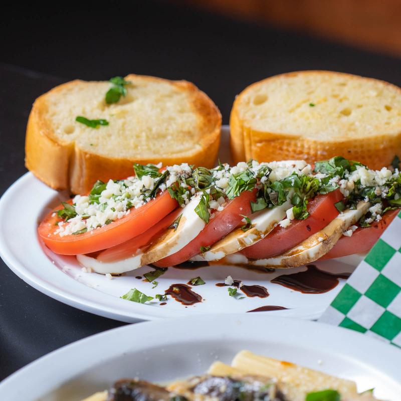 Caprese salad with a side of bread.