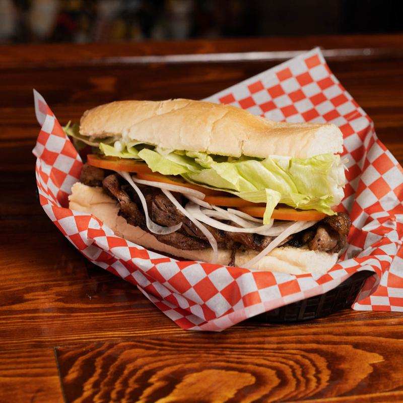 Beef and vegetables sandwich on top of a tray
