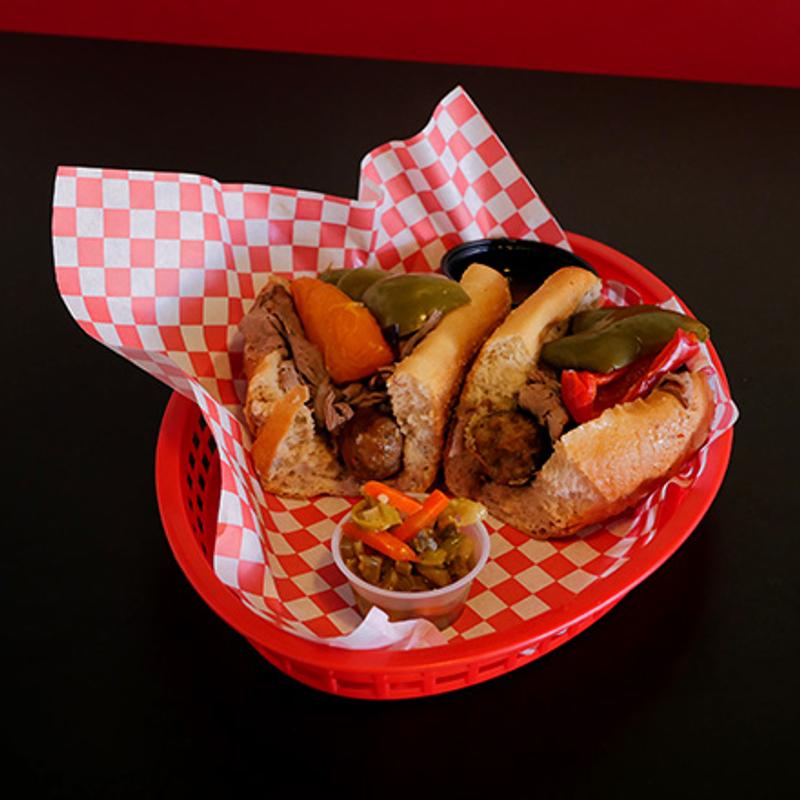 A hotdog cut in half rested on a red tray.