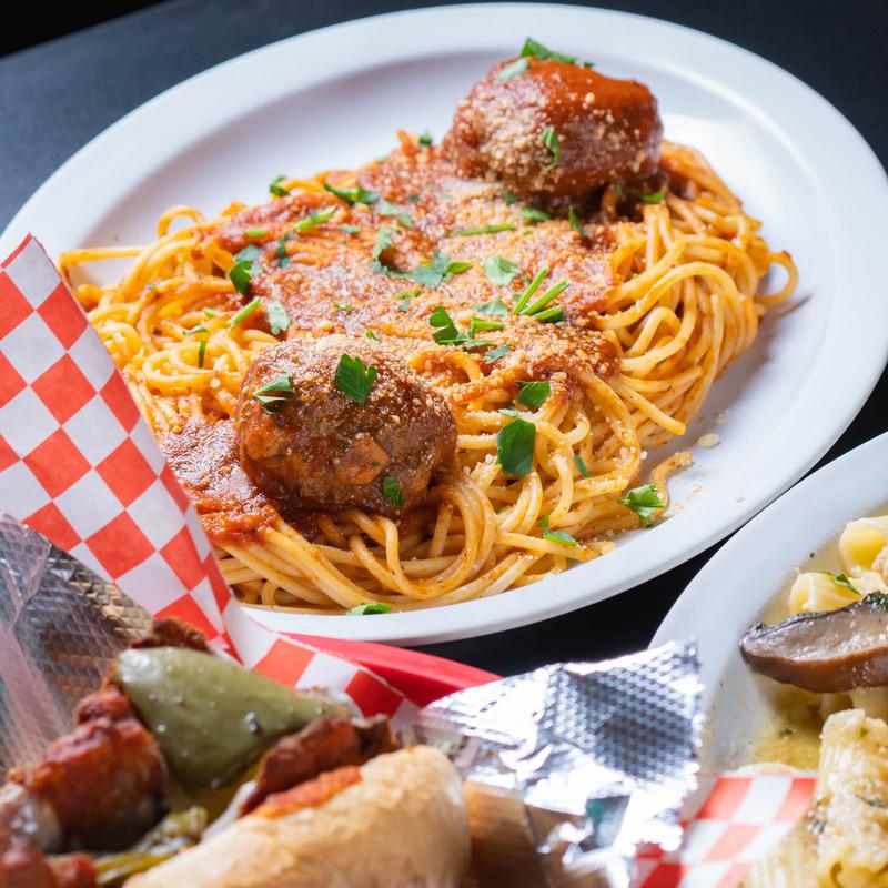 A plate featuring pasta with meatballs.