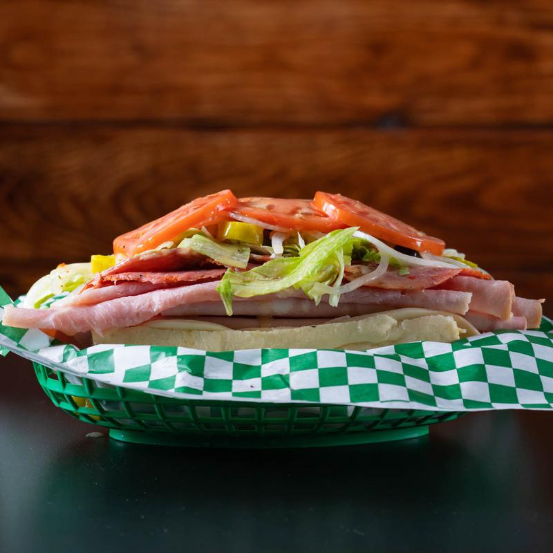 Meat and vegetables sub o top of a table