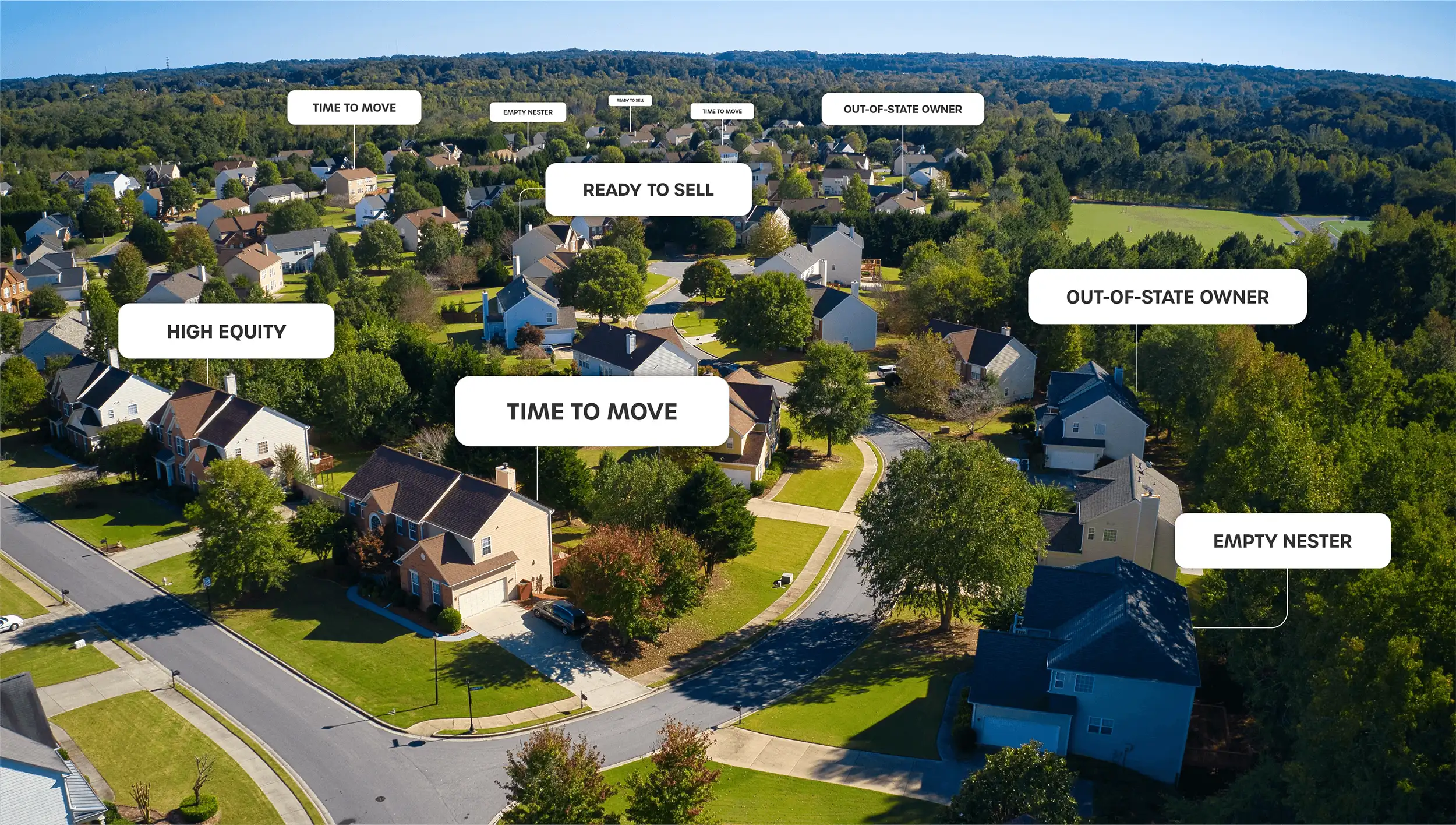 A real estate agent handing the keys to a couple of clients in front of their new house after closing.