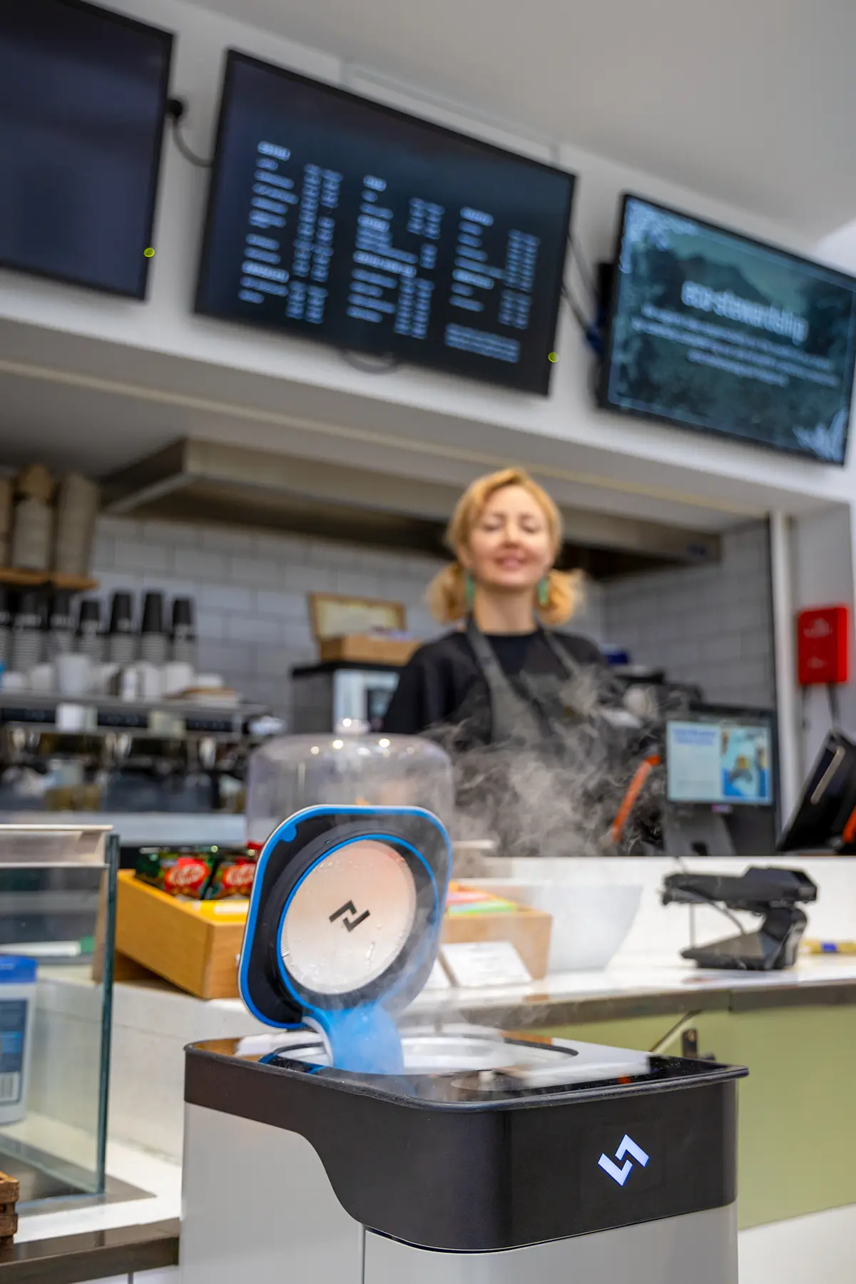 Close-up of reusable cup being cleaned in instarinse cup cleaning machine designed for sustainable cup reuse.