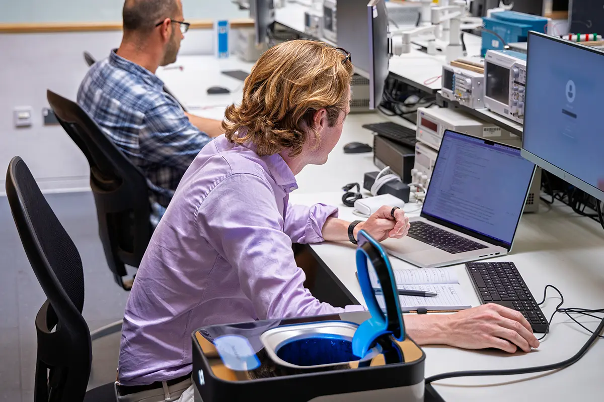 Theo, CEO of Lava Labs, sitting at his desk with an instarinse machine beside him.