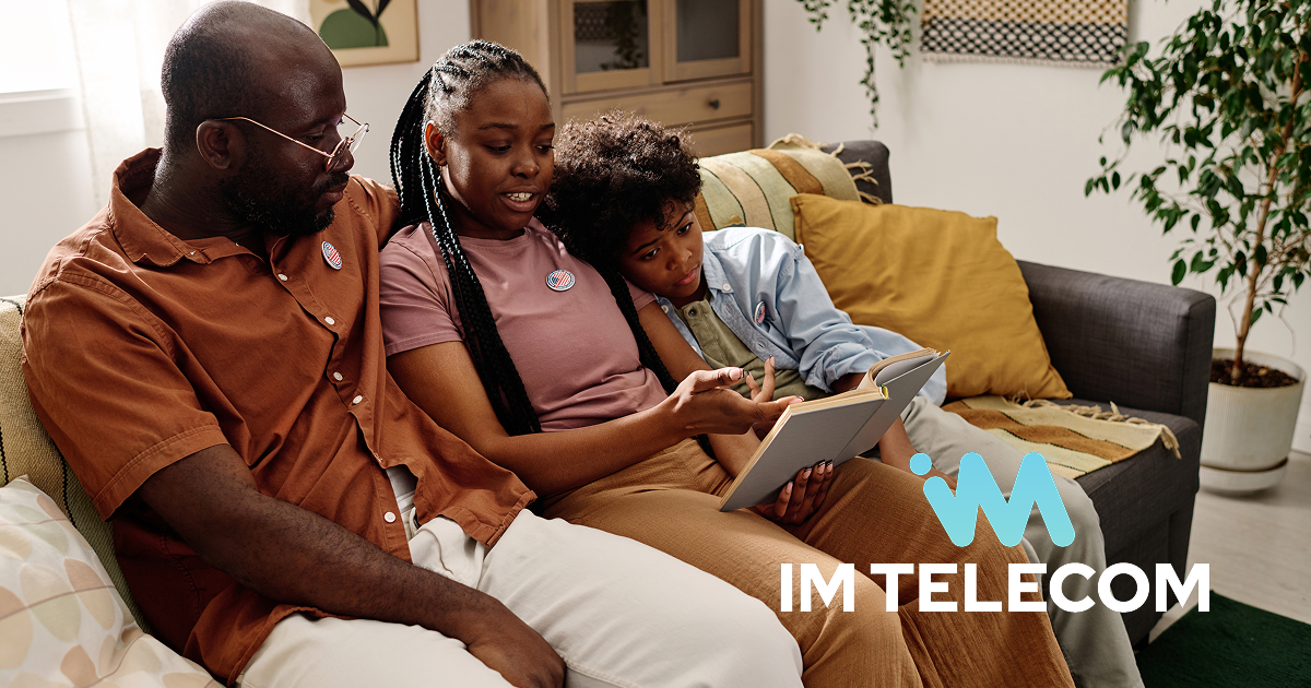 A father and his two children reviewing their federal lifeline wireless program through IM Telecom