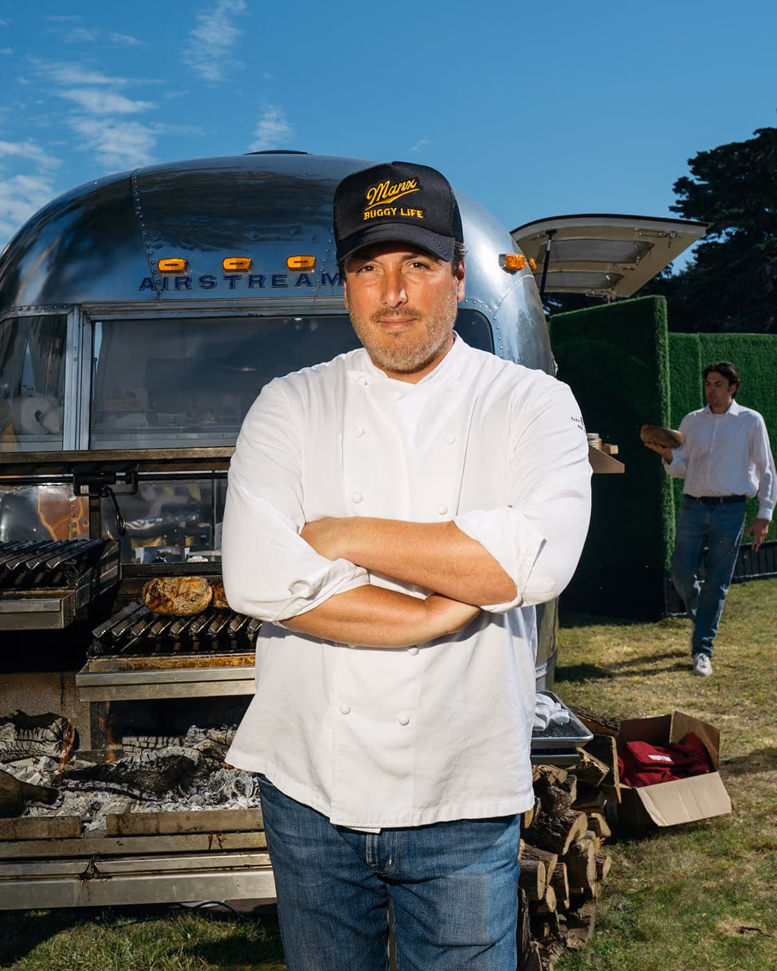 Chef Yann Nury standing in front of airstream with arms crossed looking at the camera