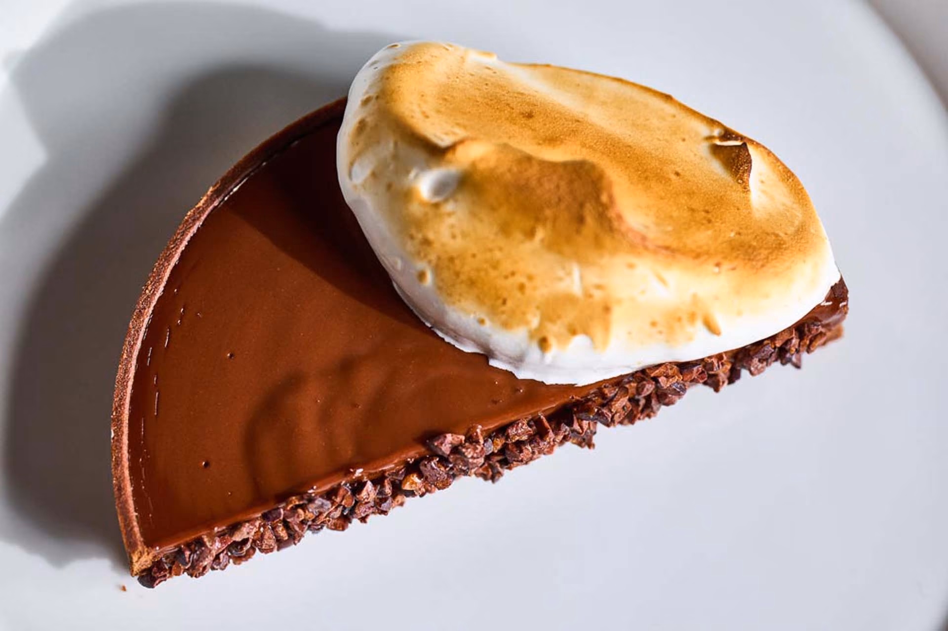 Overhead chocolate tart topped with torched meringue