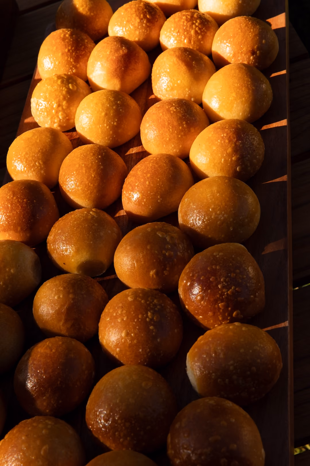 Close-up of a tray of golden baked bread rolls