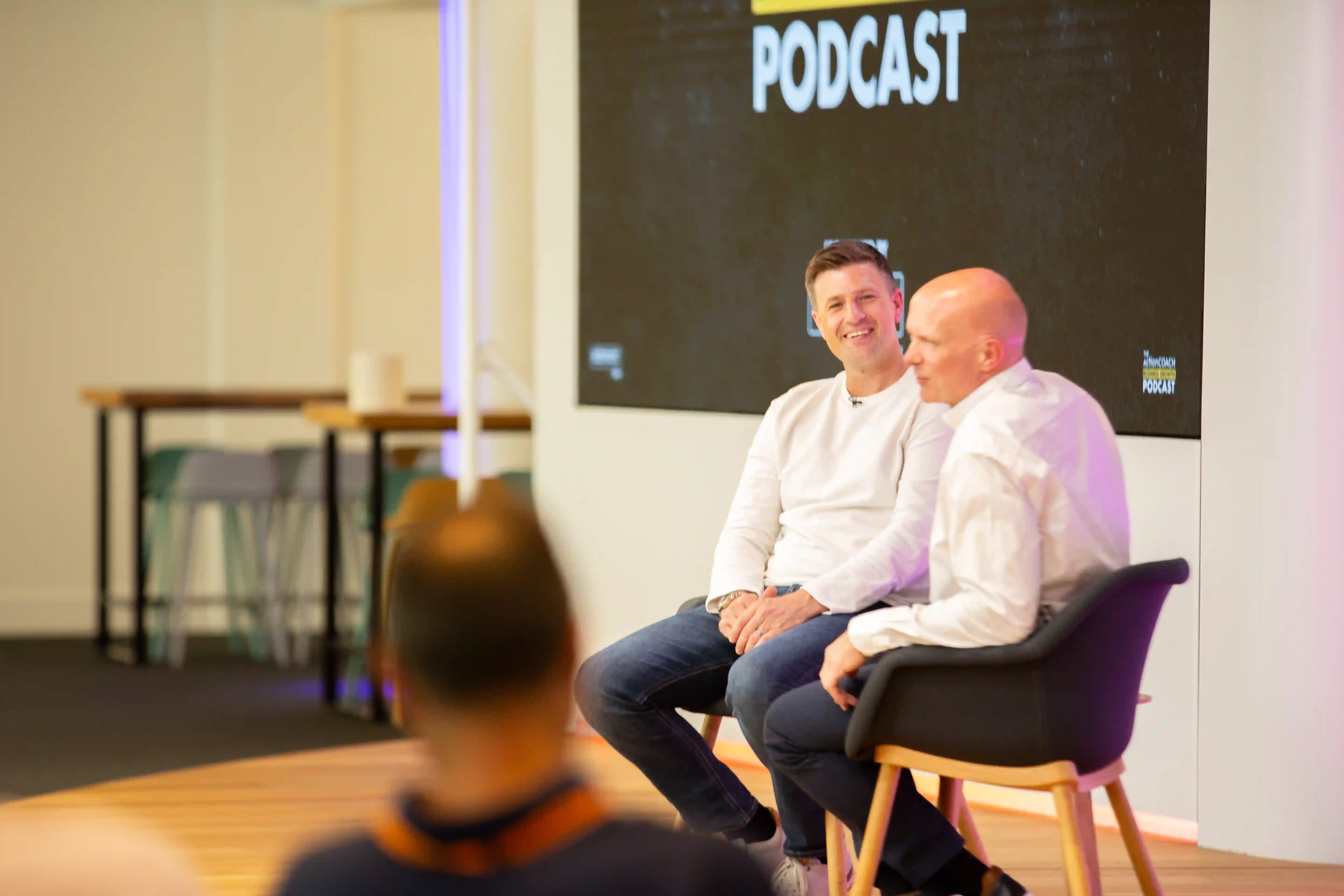 James Vincent recording a podcast episode in front of a crowd.