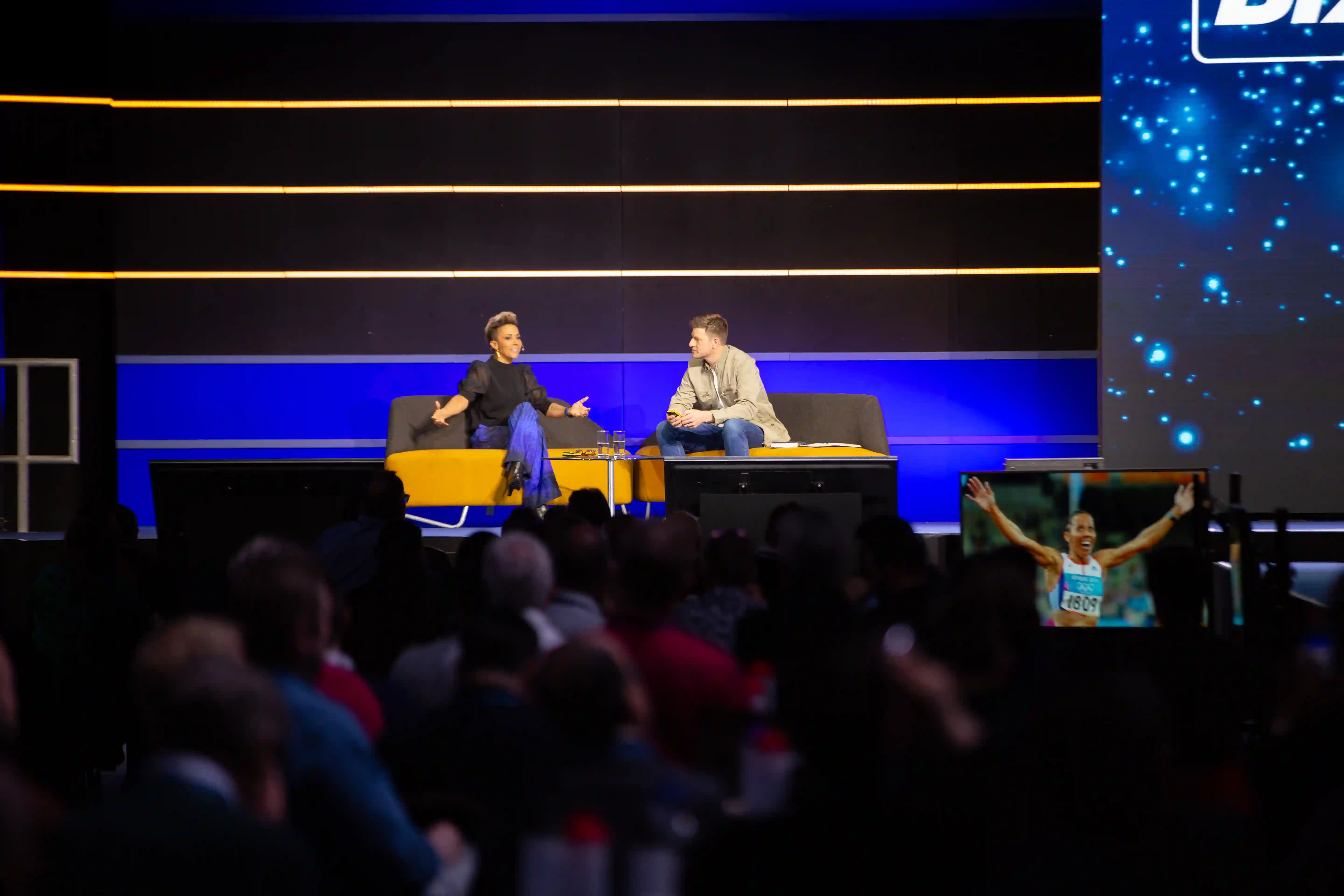 James Vincent recording a live podcast episode on stage in London