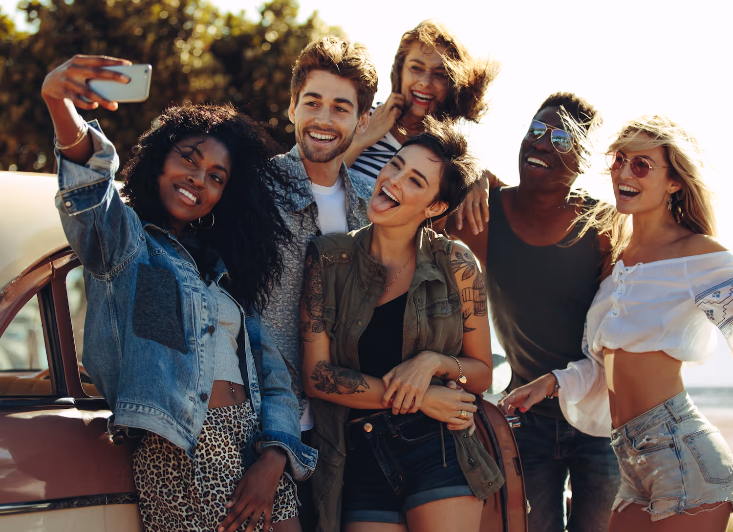 A group of friends smiling and taking a selfie outdoors, representing the vibrant social life near Ascension at Ironwood in Tucson, AZ.
