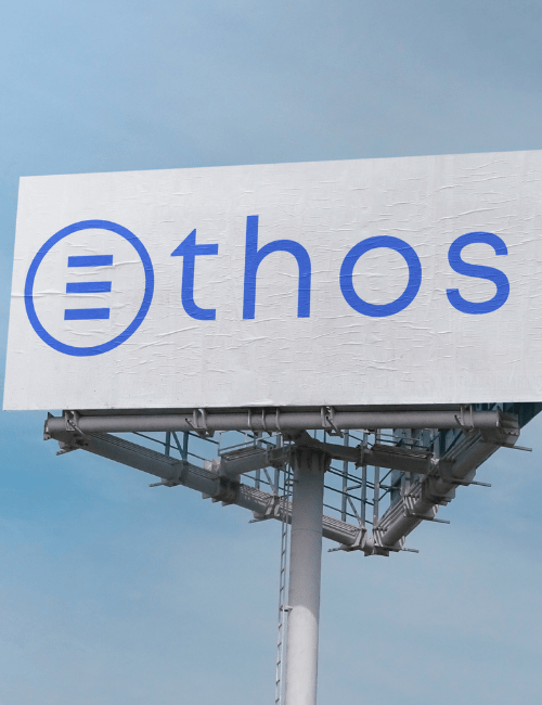 A billboard that has The Ethos Team logo on it and clear skies in the back.