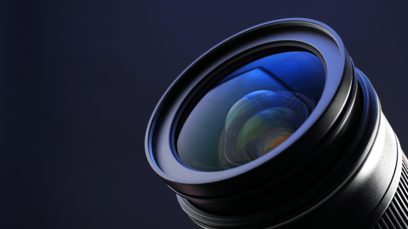 A camera lens with a dark background.