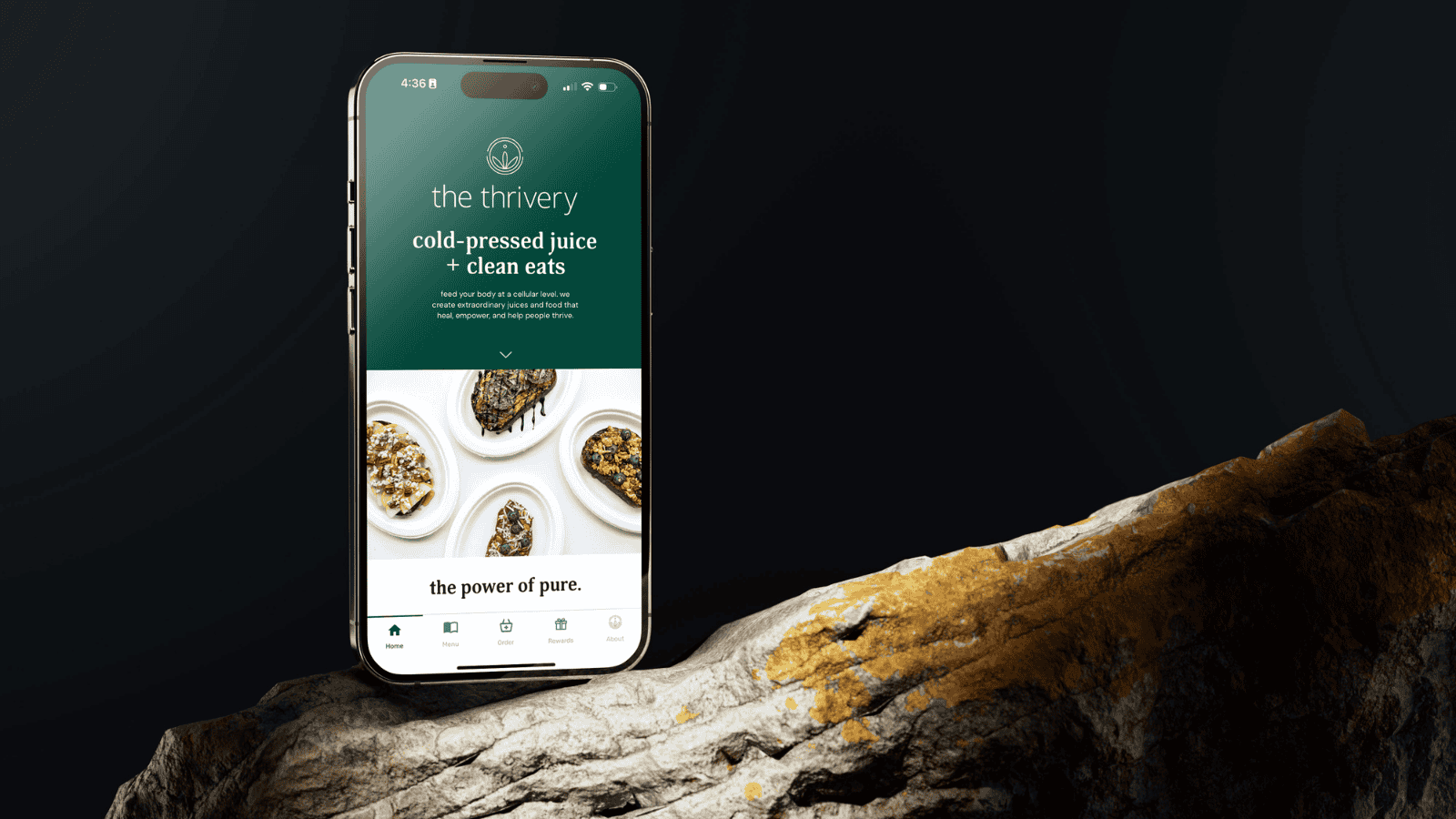 A phone sitting on a log with a dark background.