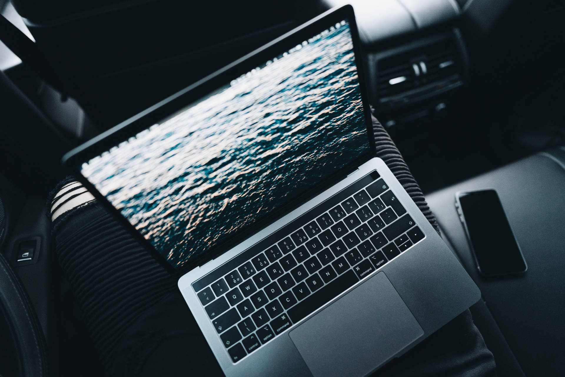 A laptop sitting in a car.