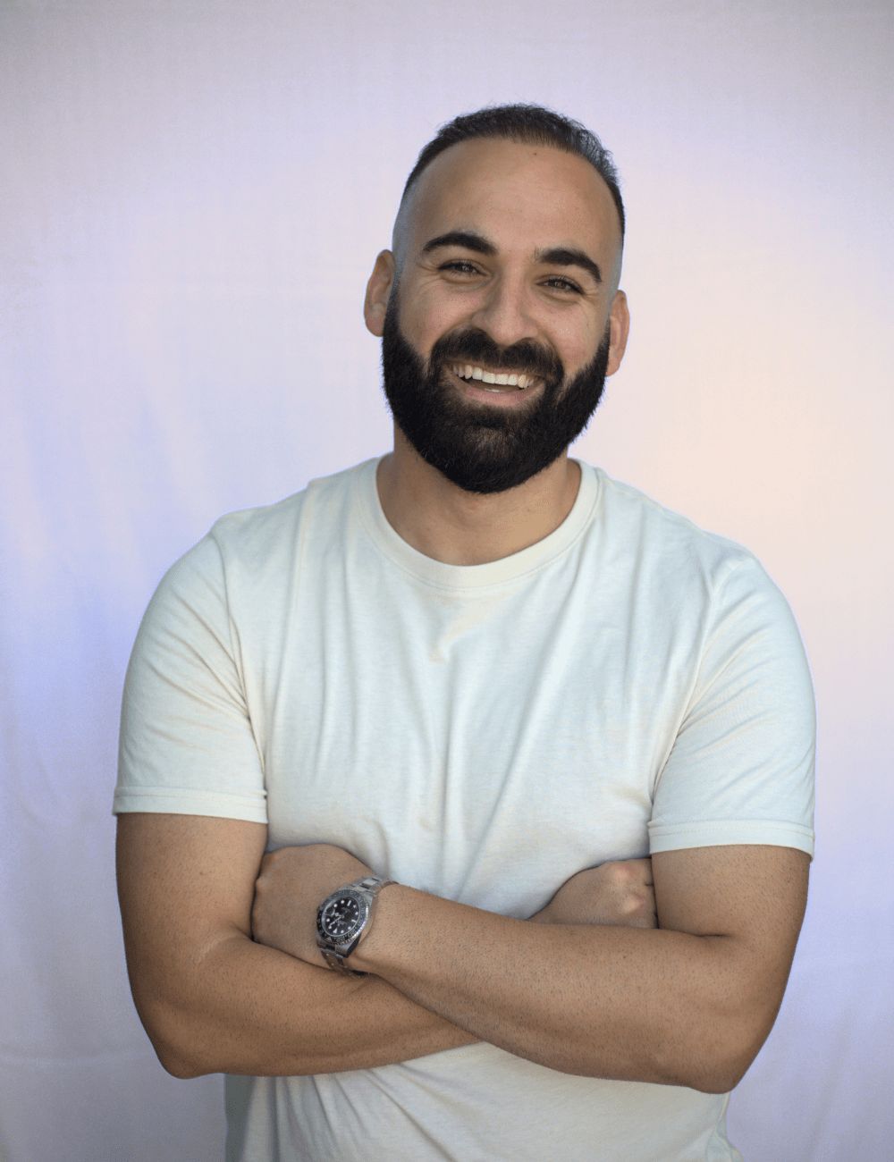 A man posing with his arms crossed.