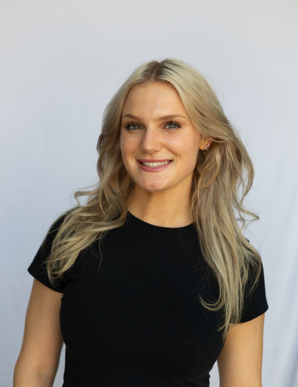 A girl in a black shirt posing for a picture.