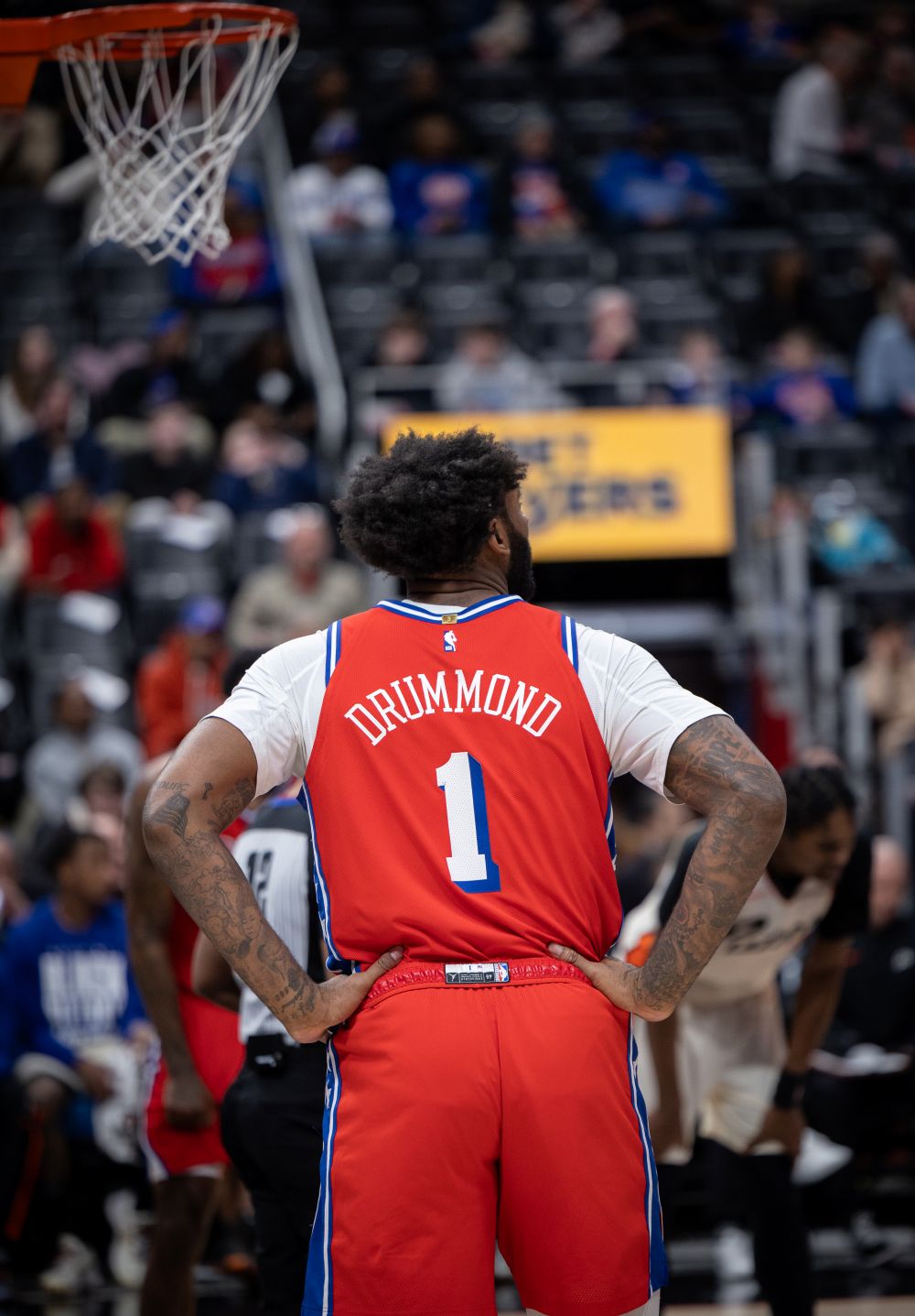 Andre Drummond standing with his hands on his hips on a basketball court.