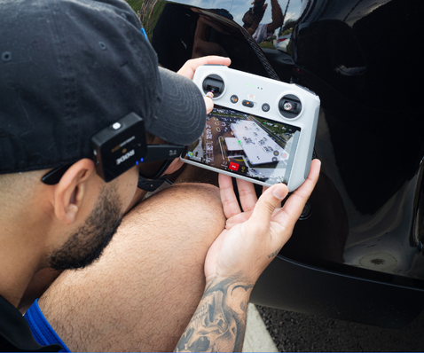 Drone operator checks navigation screen with city map view