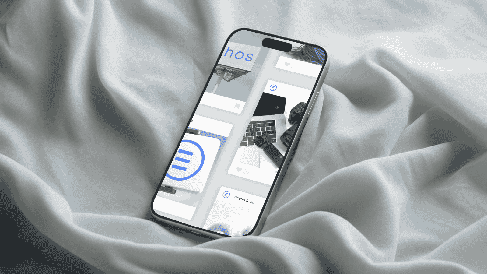 Smartphone displaying HOS app interface with laptop and workspace items