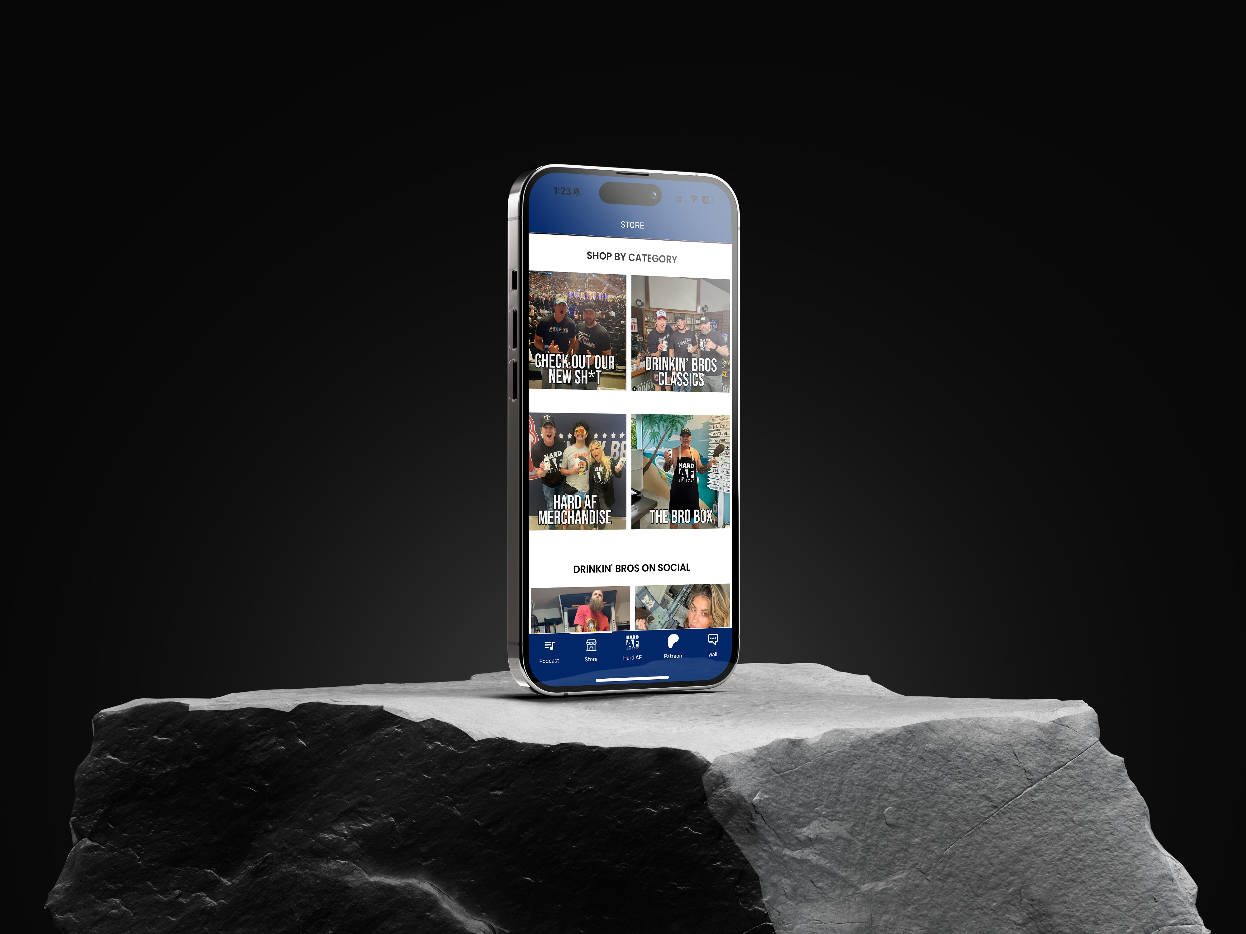 Smartphone displaying Drinkin' Bros mobile app store page on rocky surface