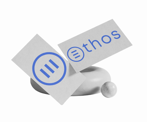 Ethos logo on angled white cards with blue geometric elements
